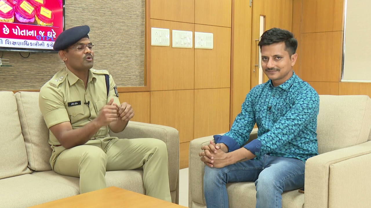Sanjay Kharat in uniform seated in an armchair in conversation with an interviewer during a recorded discussion.